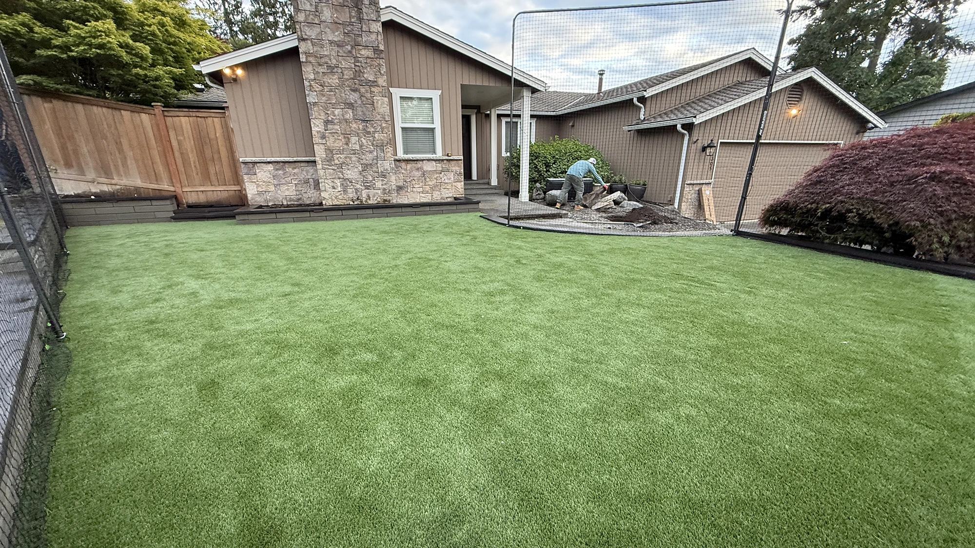 Completed front yard artificial turf with block borders in Kirkland, WA
