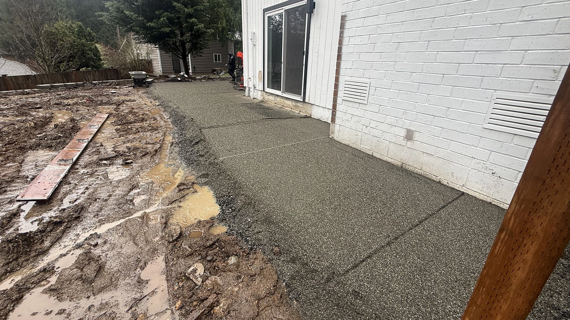 Exposed aggregate concrete walkway poured along the house in Bothell, WA