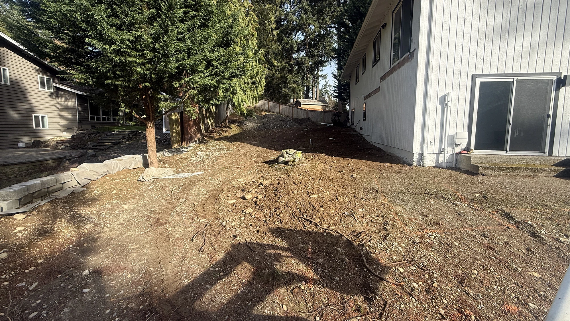 Empty dirt side yard along the house before the paver patio in Bothell, WA
