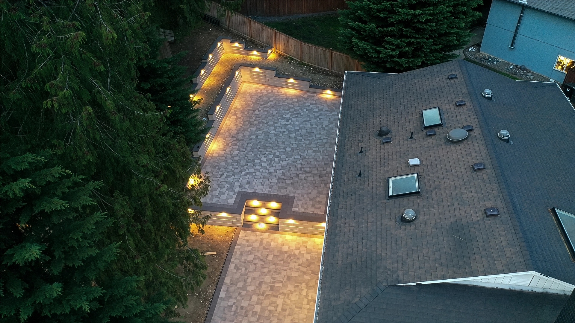Aerial night view of the lit paver patio and retaining walls in Bothell, WA