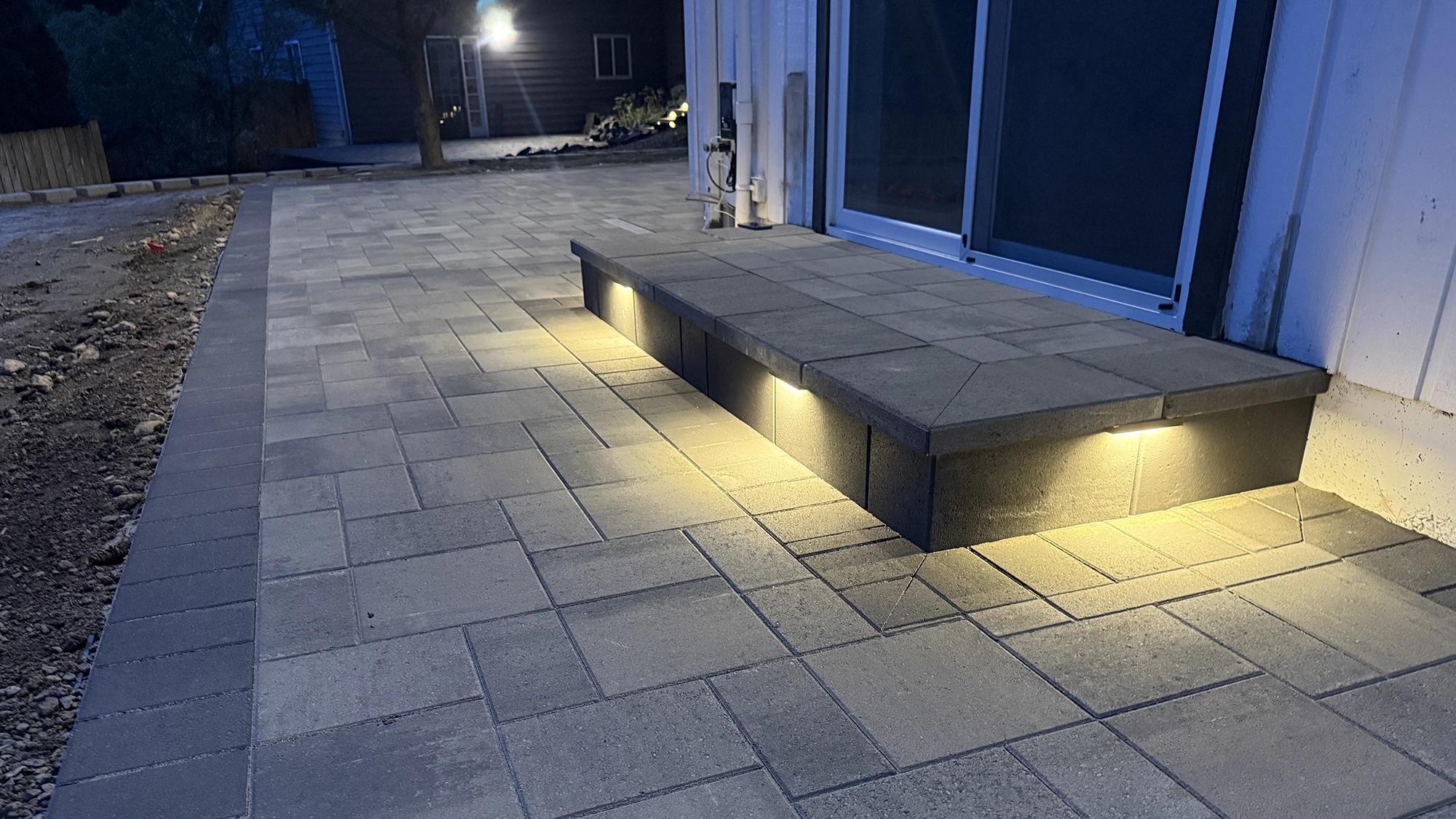 Paver walkway and lit step at the sliding door in Bothell, WA