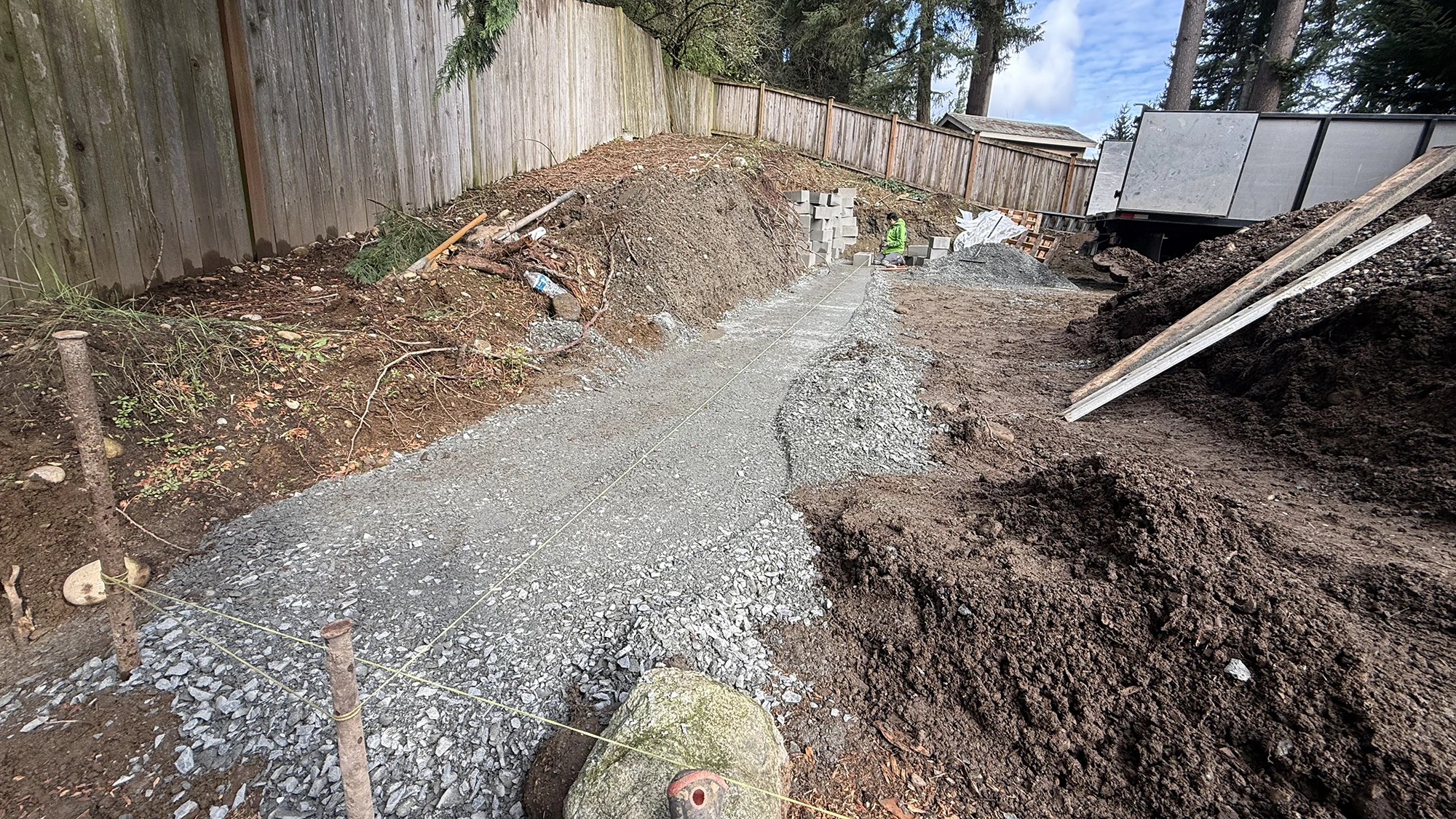 Compacted gravel base and string lines for the paver layout in Bothell, WA