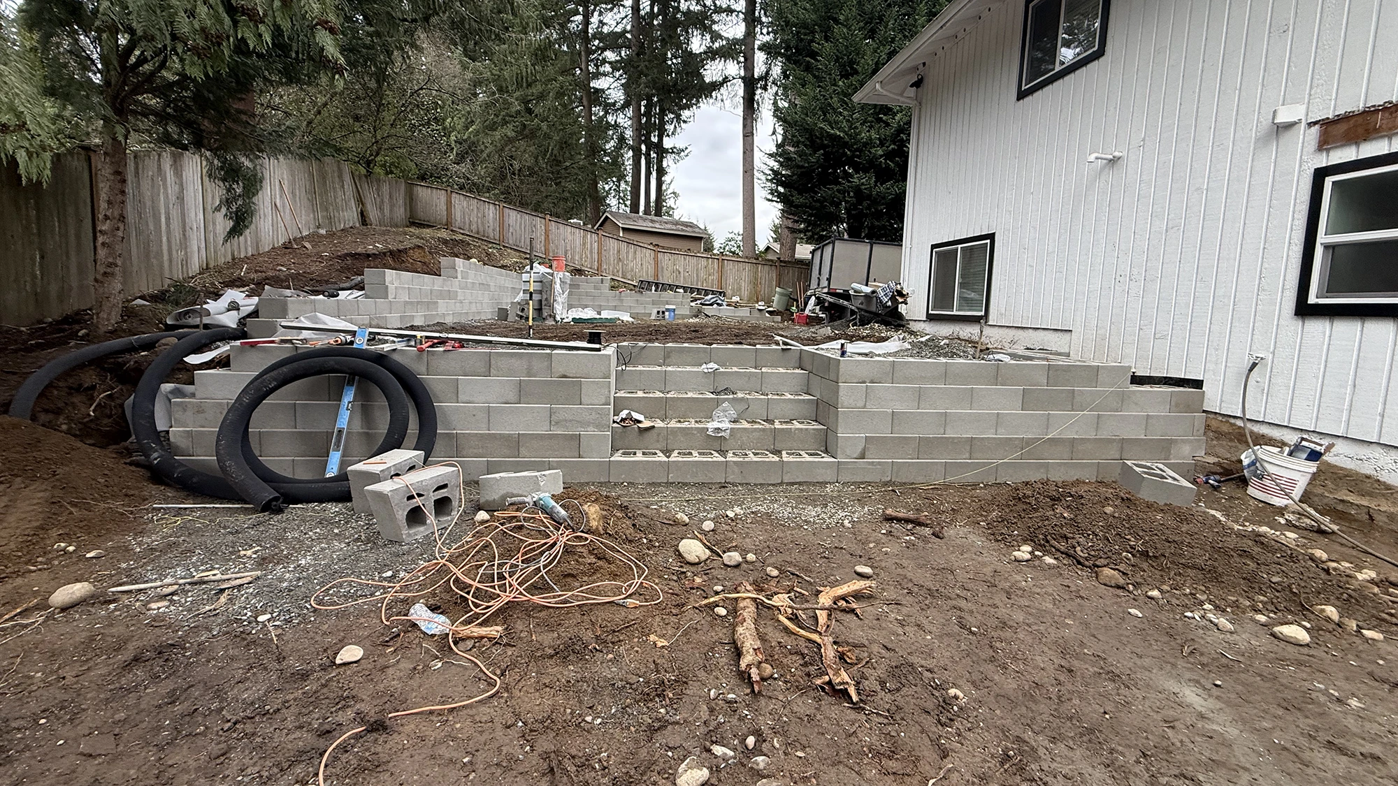 Concrete block retaining wall and built-in steps under construction in Bothell, WA