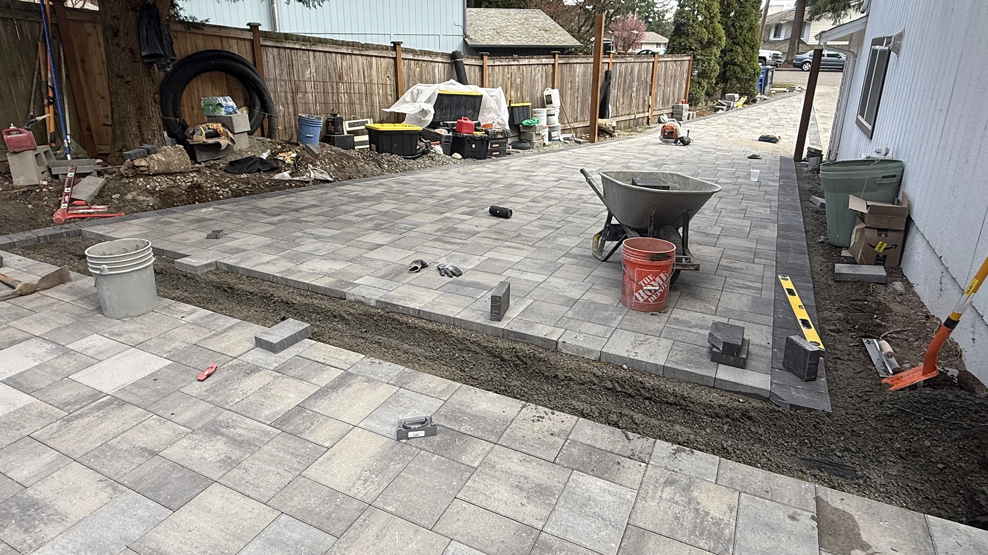 Paver patio installation along the side of the house in Bothell, WA