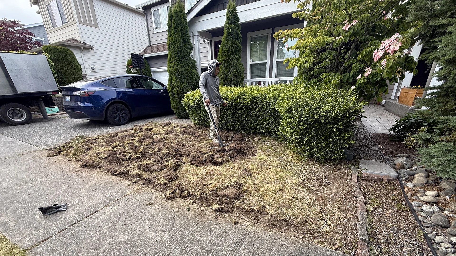 Removing the old front lawn before installing new sod in Mill Creek, WA