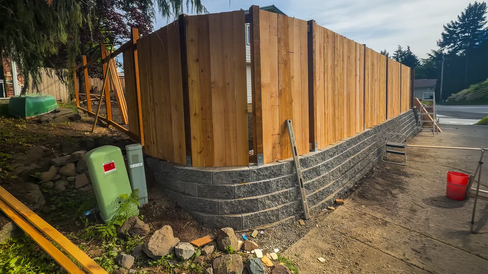 Retaining wall with a cedar fence above it along the sidewalk in Federal Way, WA