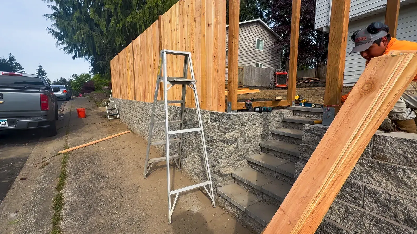 Cedar fence panels going up on top of the new retaining wall in Federal Way, WA