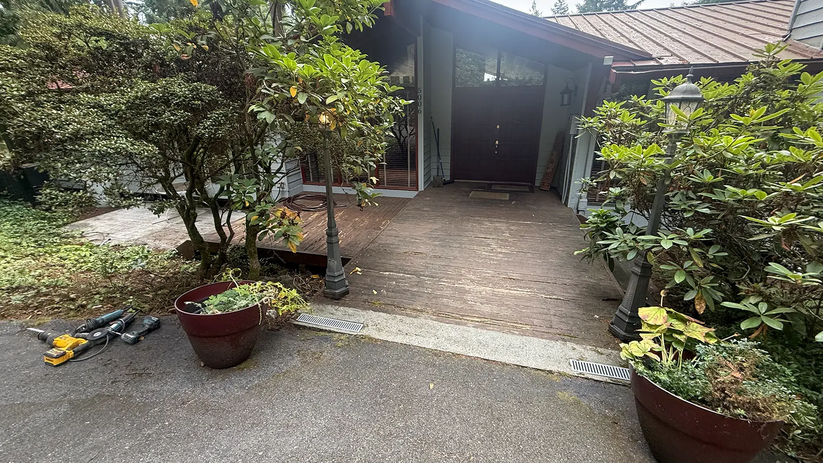 Old wood deck at the front entry of a home in Bothell, WA before the paver patio