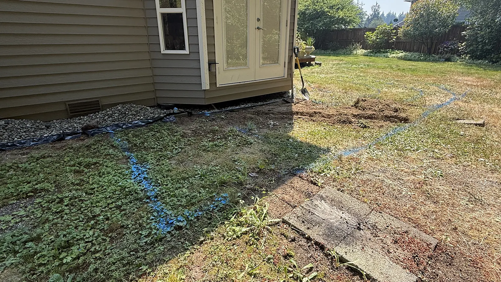 Paver patio layout marked with paint next to the house in Duvall, WA