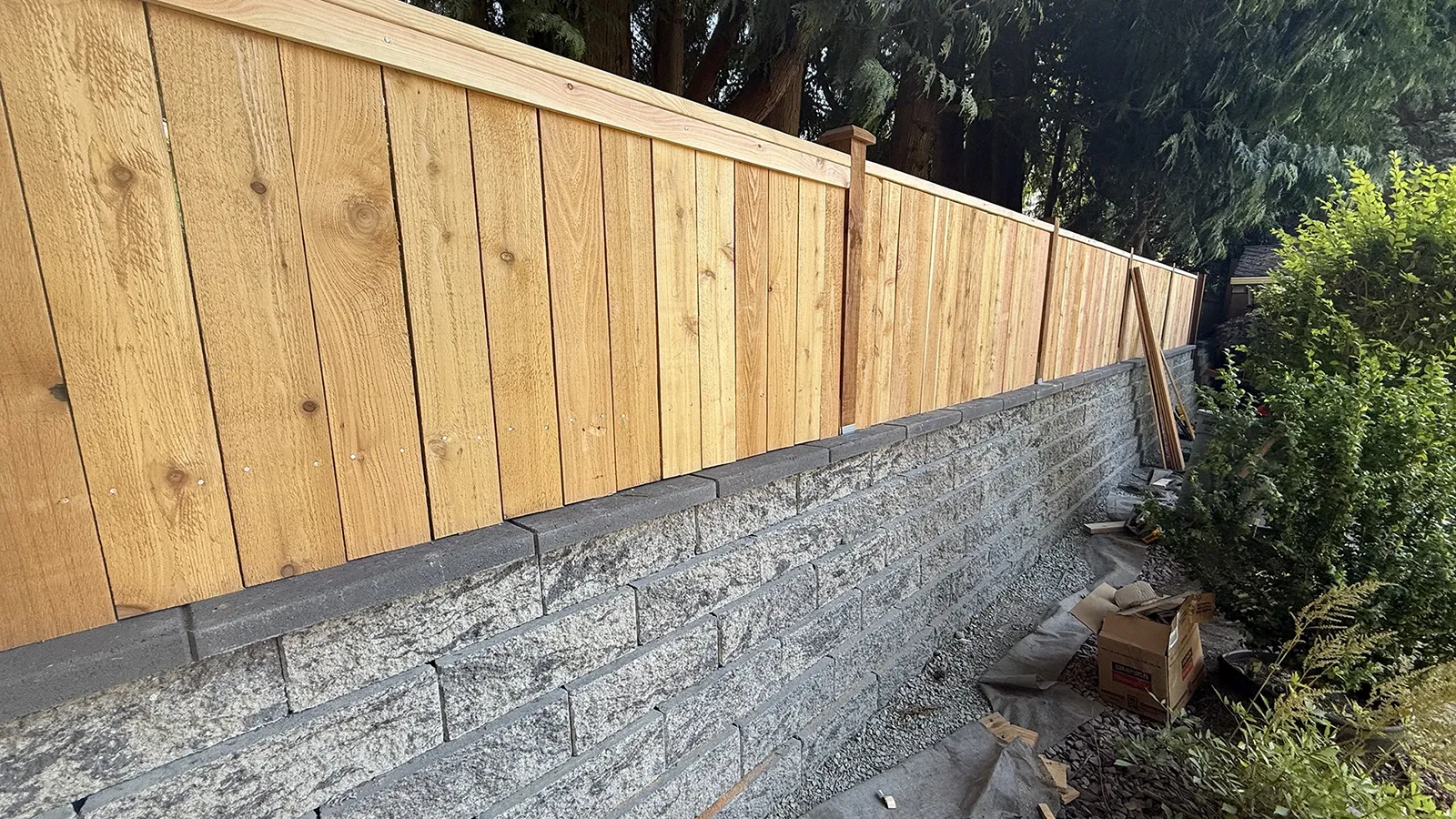 Cedar fence installed on top of a block retaining wall in Matthews Beach, Seattle