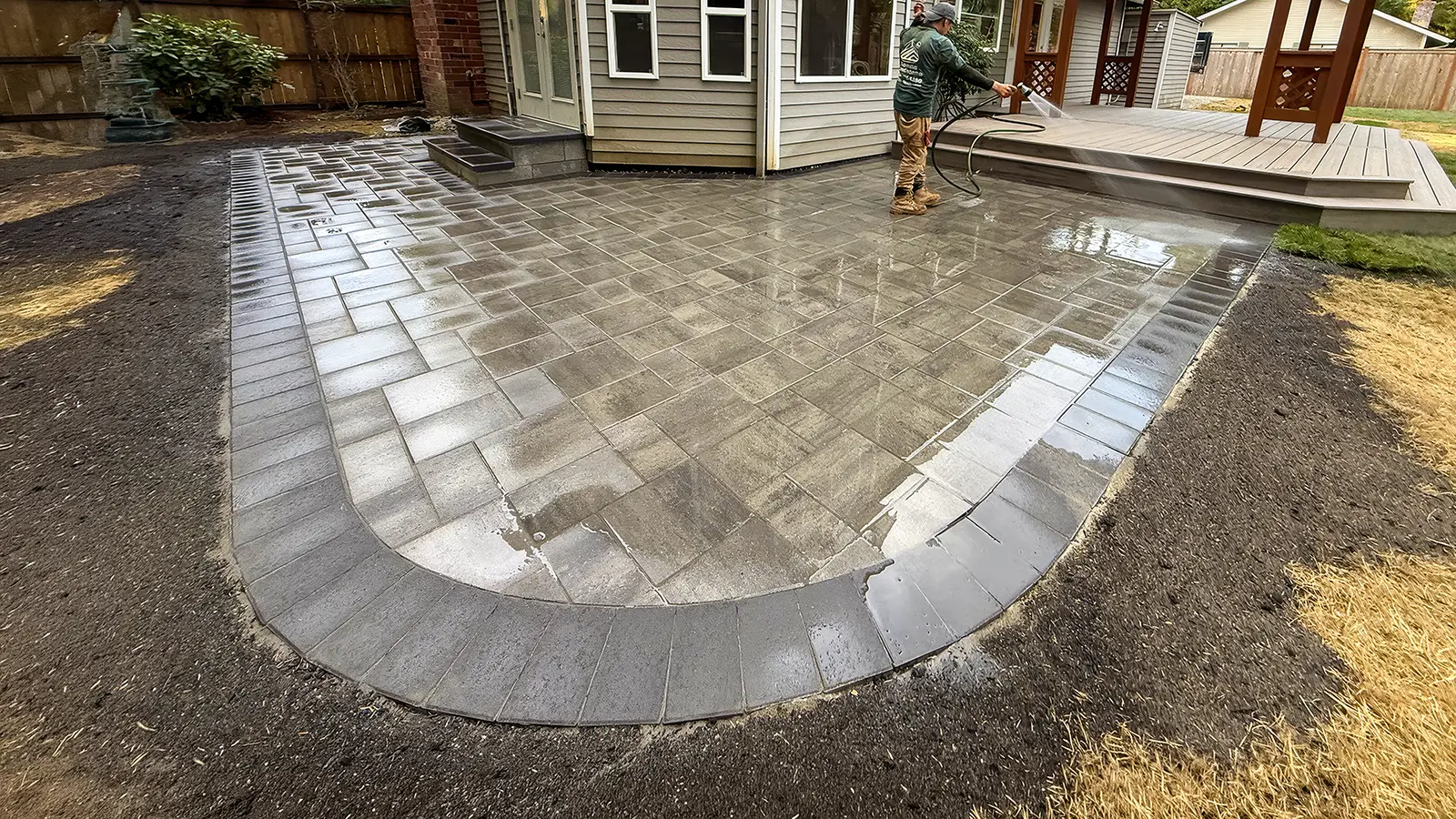 Completed paver patio being cleaned in Duvall, WA by Acosta Landstone