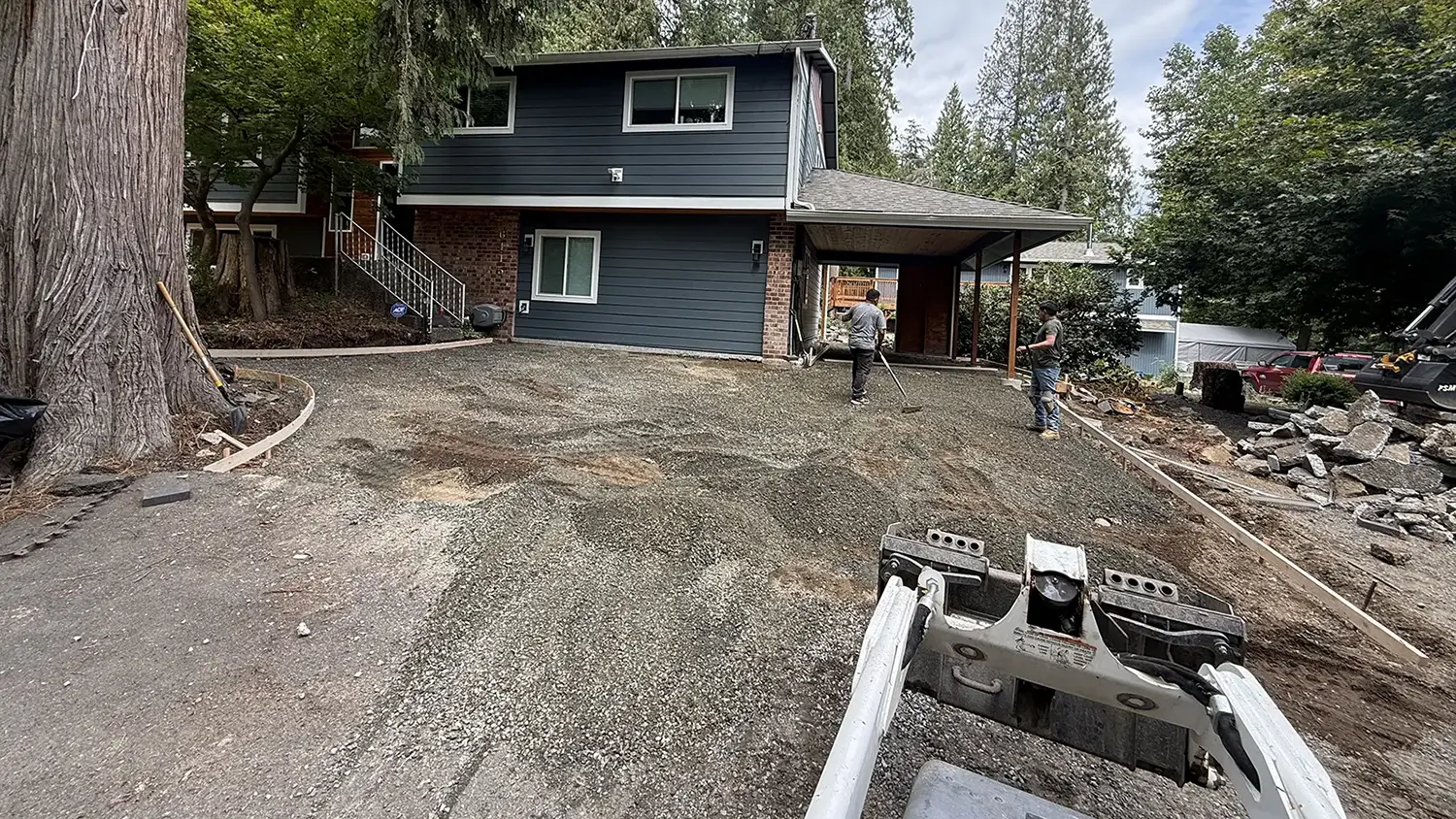 Compacted gravel base preparation for a concrete driveway in Bothell, WA
