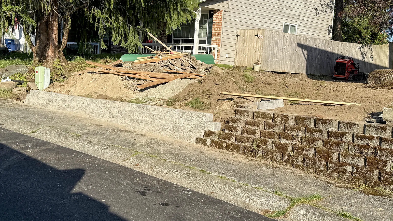 First rows of the new block wall beside the old retaining wall before demolition in Federal Way