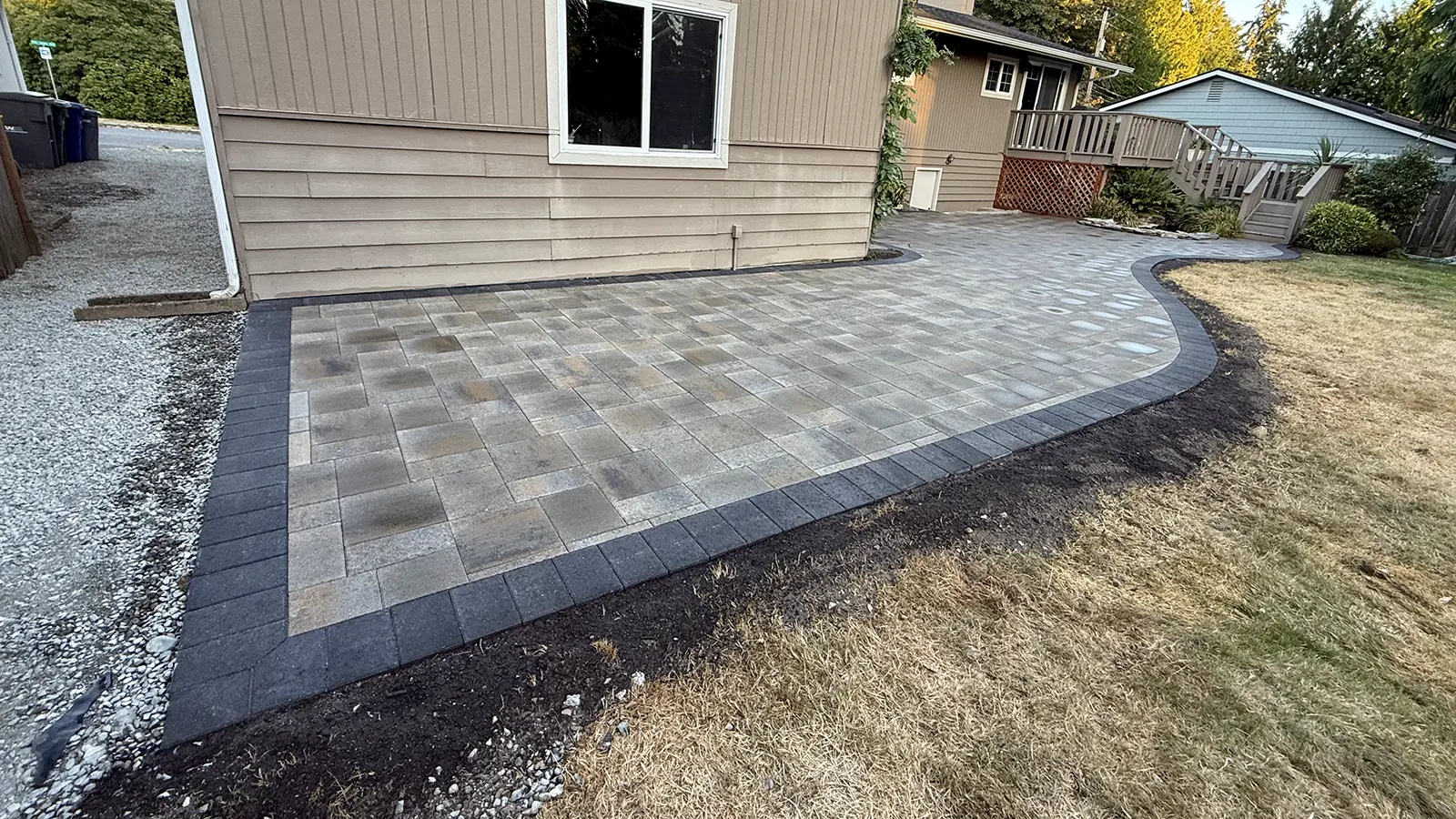 Close-up of a finished paver patio with charcoal border in Bothell, WA