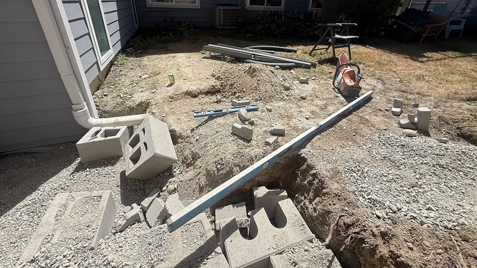 Excavating and leveling the ground with step blocks for a paver walkway in Bothell, WA
