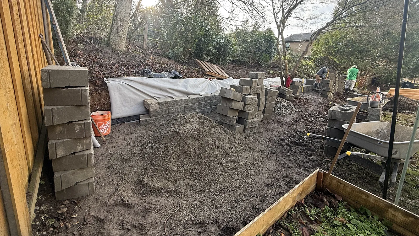 Filter fabric, drainage gravel and first blocks laid for a retaining wall in Sammamish, WA