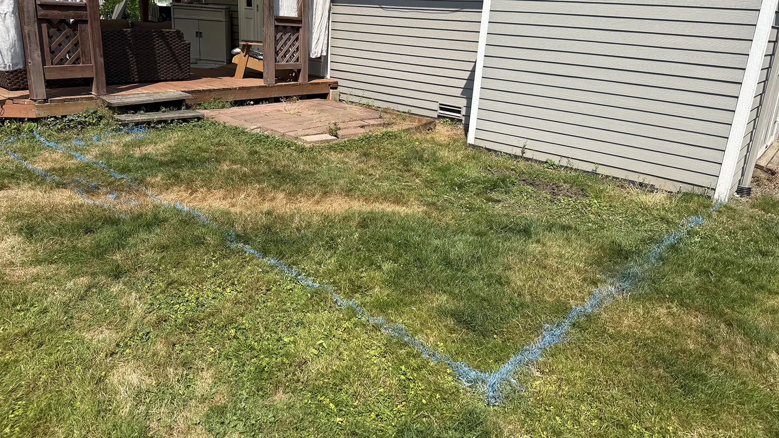 Paver patio outline marked on the lawn next to an old brick patio in Duvall, WA