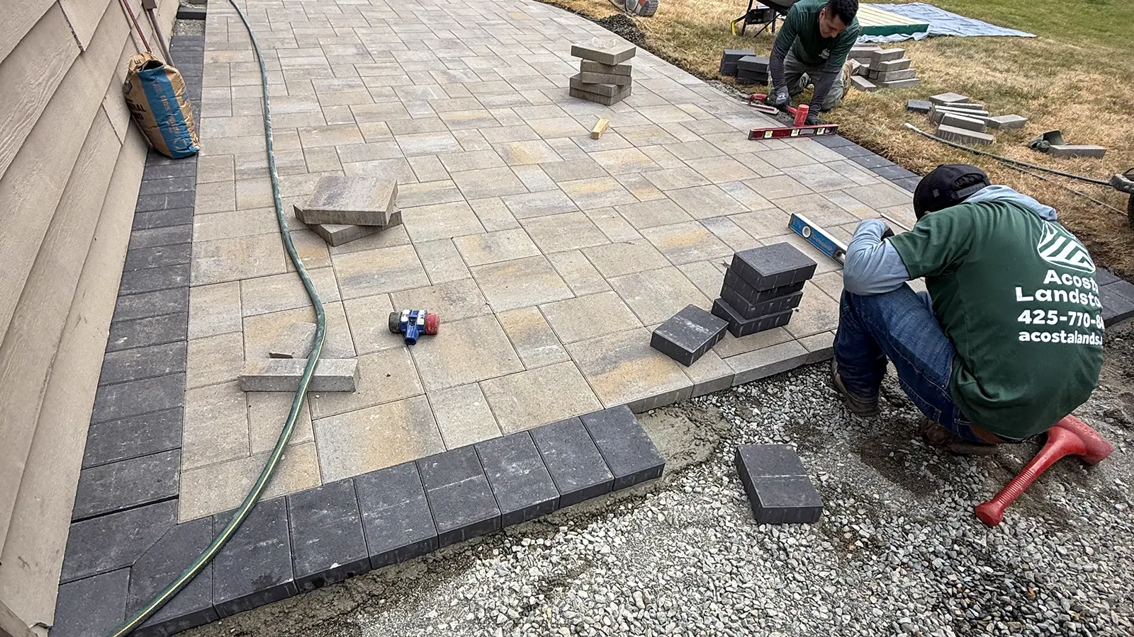Charcoal soldier border installation along the house wall in Bothell, WA