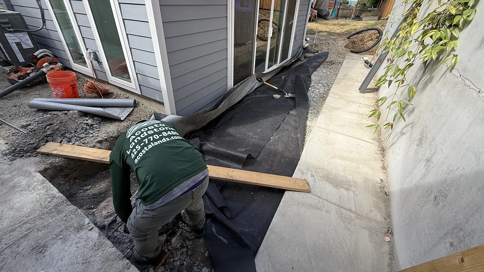 Excavation and landscape fabric along the house for a paver walkway base in Bothell, WA
