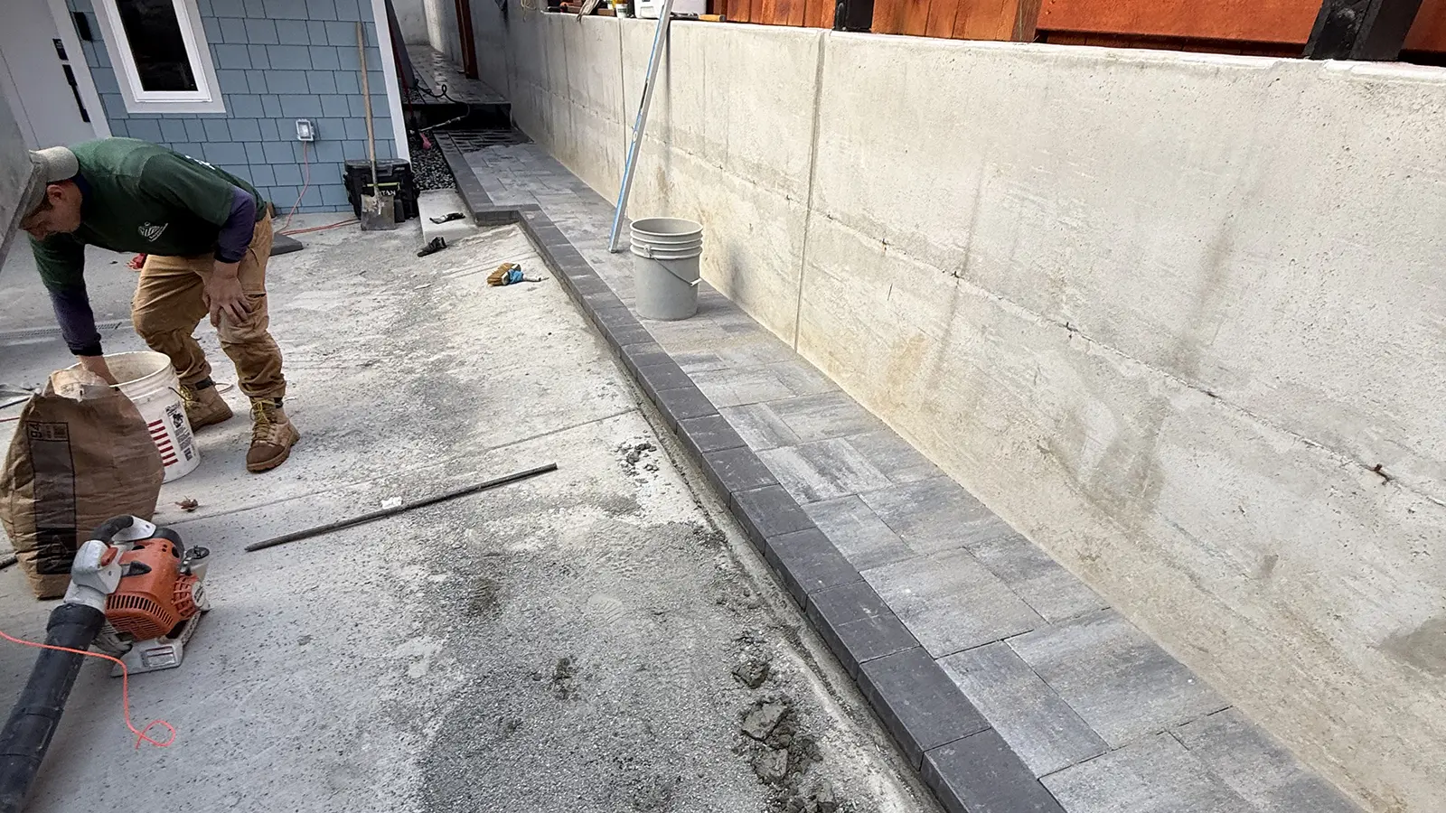Charcoal soldier border installed along a paver walkway by the retaining wall in Bothell, WA