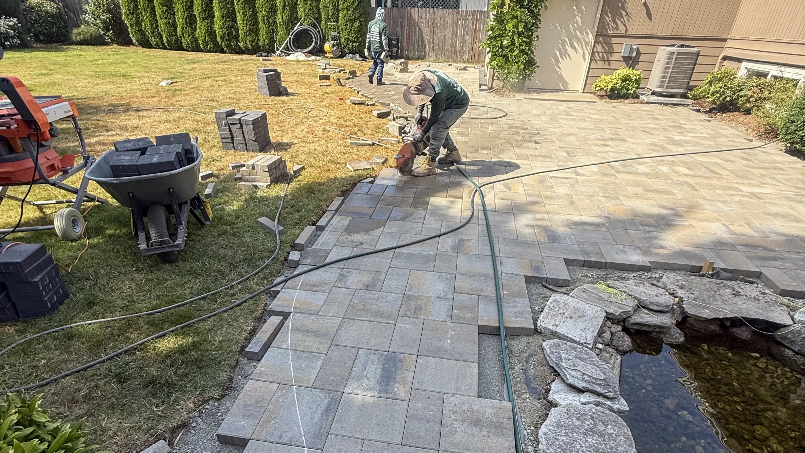 Cutting pavers along the curved edge of a paver walkway in Bothell, WA