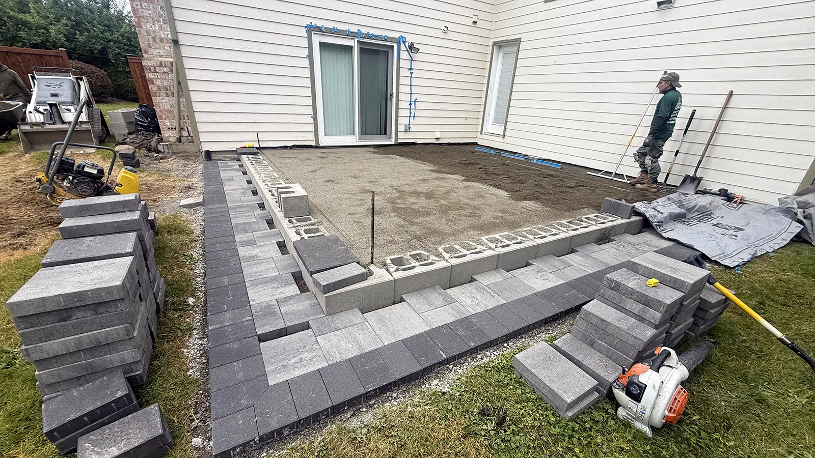 Raised paver patio with charcoal border and lower step in progress in Duvall, WA