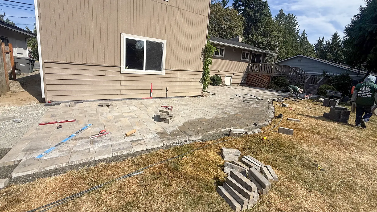 Paver patio construction along the side of a home in Bothell, WA