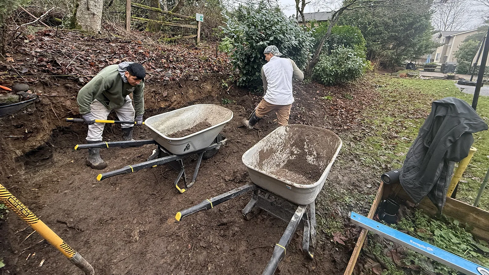 Crew excavating the slope for a new retaining wall in Sammamish, WA