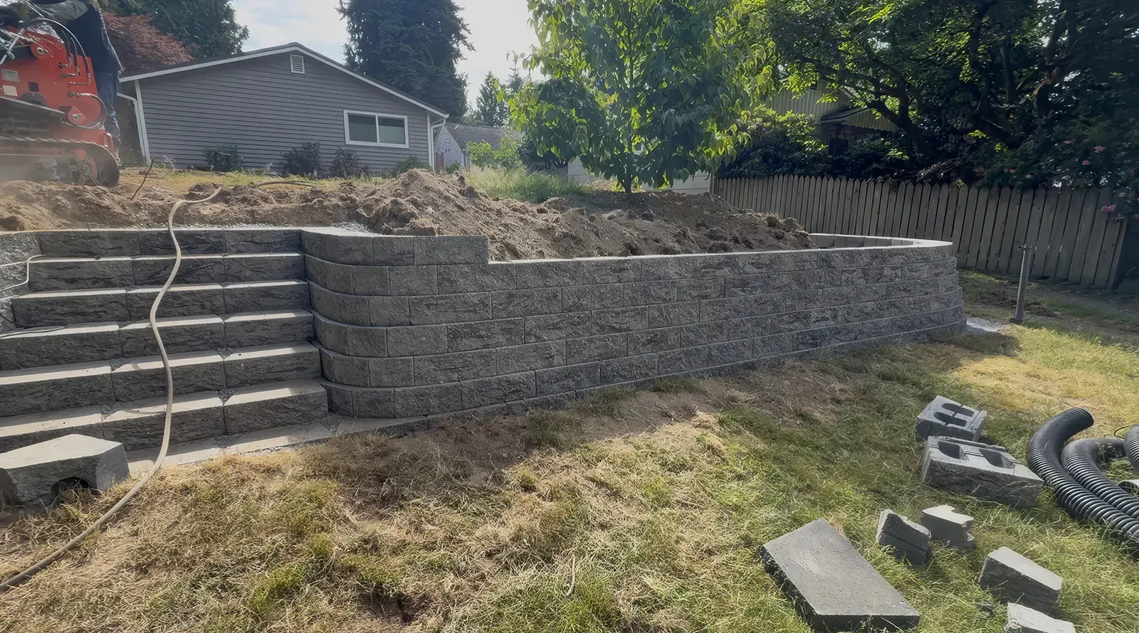 Concrete block retaining wall with built-in steps and curved returns in Seattle, WA