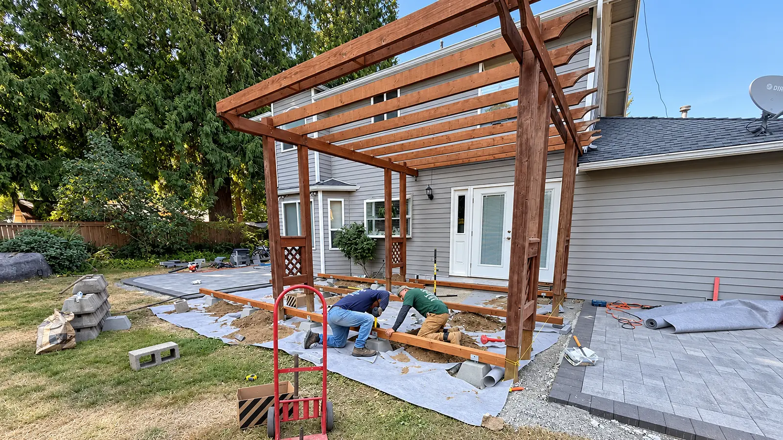 Crew setting deck beams on footings under a new wood pergola in Duvall, WA